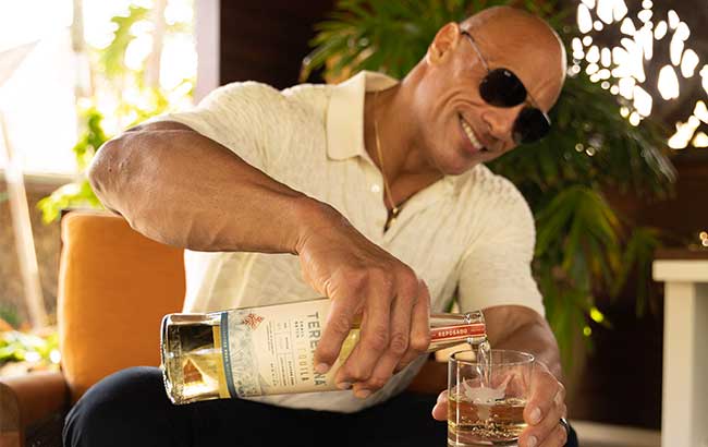 Dwayne The Rock Johson pouring himself a glass of his spirit brand, Teremana Tequila.