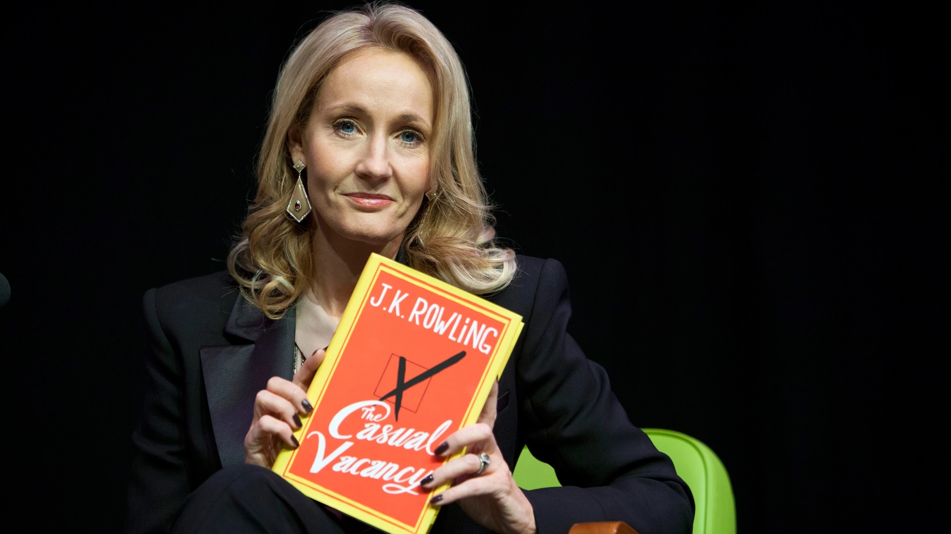 J.K. Rowling posing with her book casual vacancy.