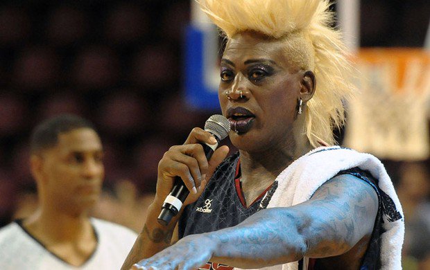 Dennis Rodman in Drag and speaking on a mic