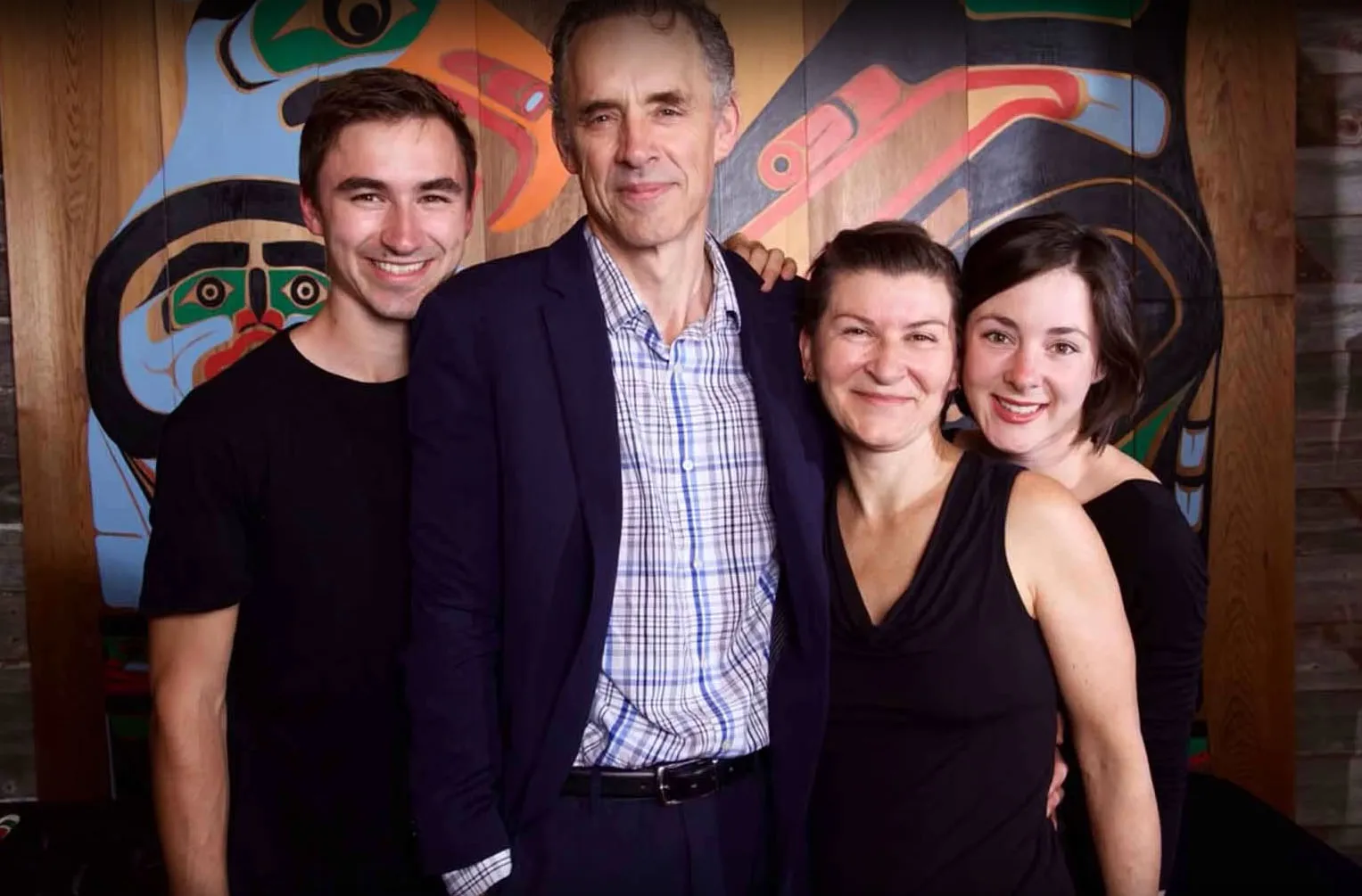 Jordan peterson posing for a picture with his wife and children.