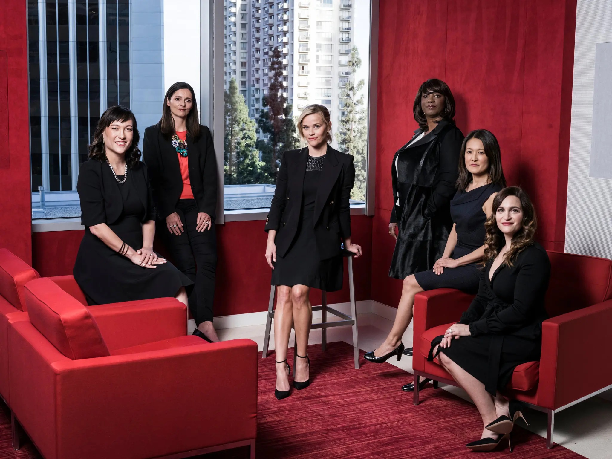 Reese Witherspoon posing with her all female production team.