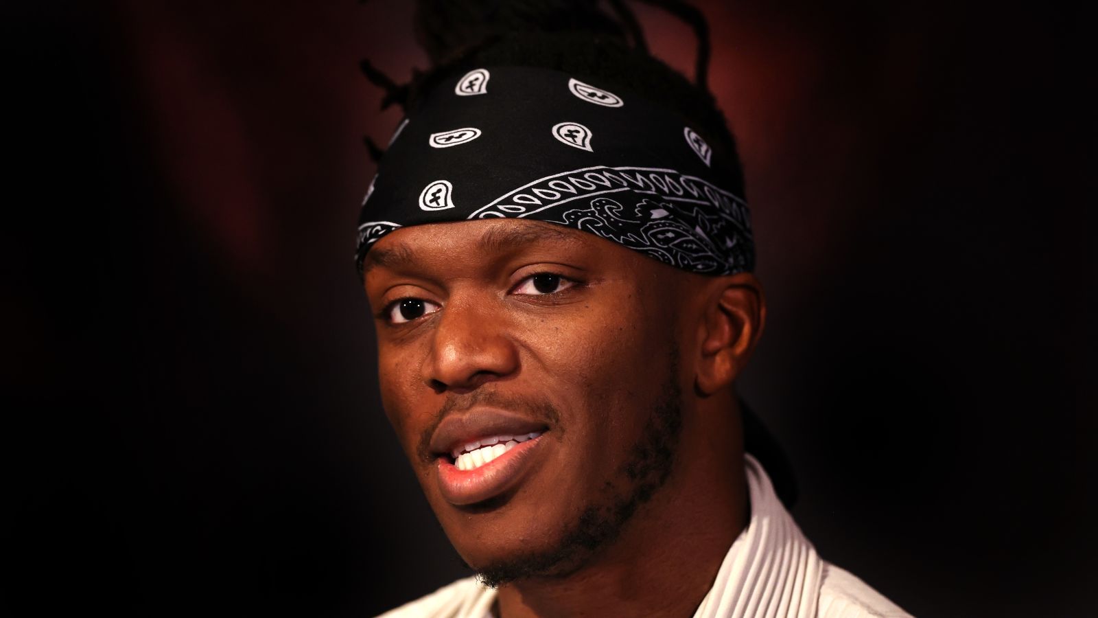 Potrait Image of KSI wearing a black bandanna with white designs